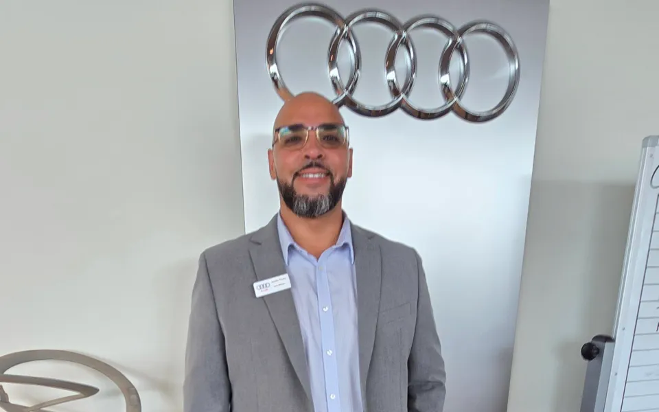 Sales manager at a car dealership showroom