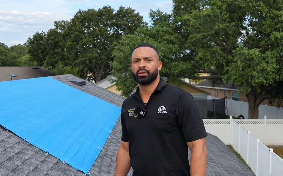 Roofing contractor standing on a residential roof during a job