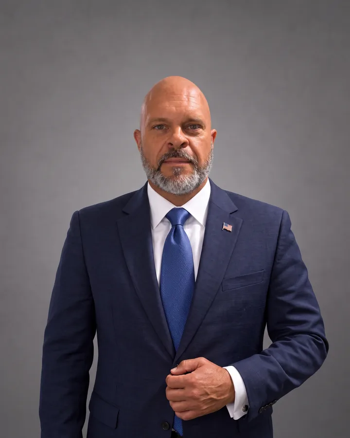 Portrait of Greg Filipkowski, Chief Technology Officer of Insight Pros, in a navy suit and blue tie