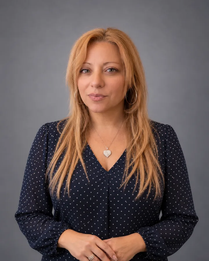 Portrait of Jacqueline Texidor, Vice President of Insight Pros, in a navy polka-dot blouse